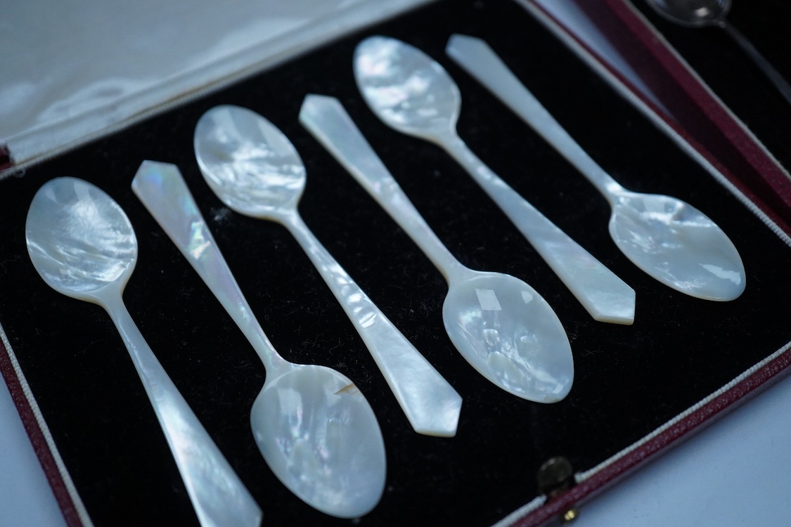 A cased set of six silver gilt and enamel coffee spoons, Adie Brothers, Birmingham, 1966, together with two other cased sets of coffee spoons including a mother of pearl set and a silver set.